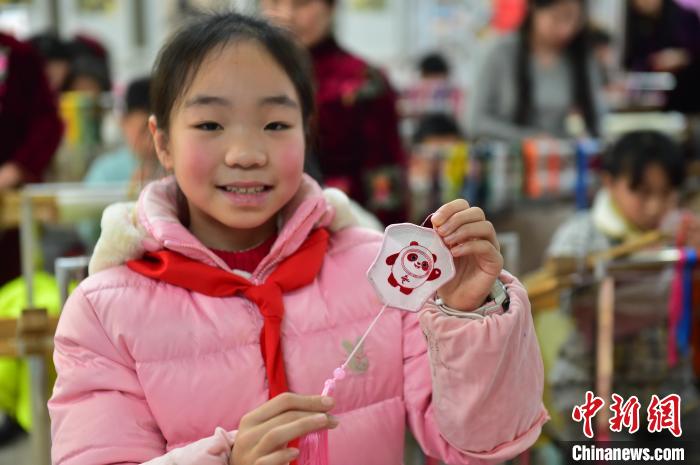 圖為一名小學(xué)生繡制的2022年北京冬奧會(huì)吉祥物“冰墩墩”形象。　喻云亮 攝